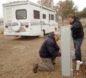 Tim Ertz, a maintenance worker at High Valley RV Park in Boise, checks an electric meter with property manager Spencer Freedman. (Photo by Geoff Hadfield)