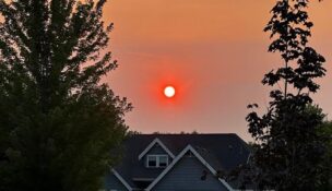 The sun glows red over a neighborhood in Meridian. It shows an example of how smoky skies have been over the Treasure Valley for weeks due to wildfires. (PHOTO: Steve Lombard, IBR)