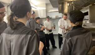An instructor demonstrates a technique for students at Life's Kitchen. (PHOTO: LIFE'S KITCHEN)