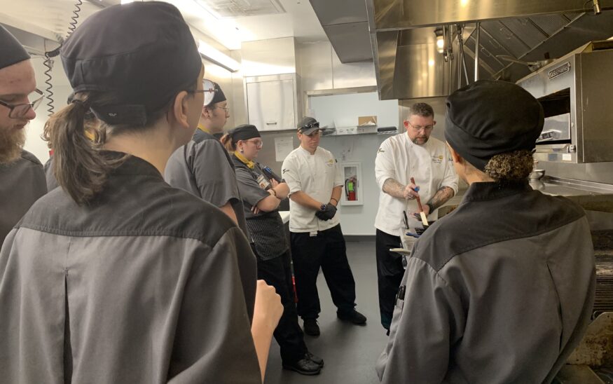 An instructor demonstrates a technique for students at Life's Kitchen. (PHOTO: LIFE'S KITCHEN)