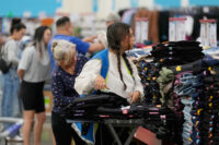 A worker stocks a display of clothing at a Sam's Club, Wednesday, Sept. 24, 2025, in Bentonville, Ark. (AP Photo/Charlie Riedel, File)