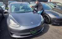 CEO of Recharged auto dealership John Foley talks to customers testing a Tesla, in Richmond, Virginia, March 13, 2026. (PHOTO: REUTERS/Valerie Volcovici)