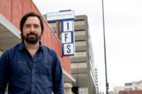 Aidan Brezonick, the founder and artistic director of Idaho Film Society, stands outside the organization's location in downtown Boise. (PHOTO: MARC LUTZ, IBR)