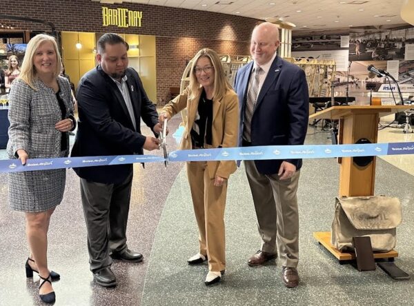 Boise Mayor Lauren McLean, center, leads the 100-year anniversary ribbon cutting ceremony. Also pictured from left to right are Rebecca Hupp, Boise Airport Director; Mike Vigil, U.S. Postal Service; and Chris Greene, RS&H architectural firm. (PHOTO: STEVE LOMBARD, IBR)