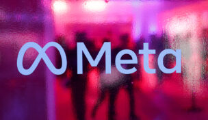 People walk behind a logo of Meta Platforms company, during a conference in Mumbai, India, on Sept. 20, 2023. (PHOTO: REUTERS/Francis Mascarenhas/File)