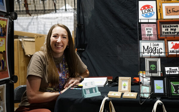 Samantha Allan, owner of WispyStitch, works on ideas in her booth at the 2026 Gem State Comic Con. The Utah-based crafter attends at least one event a month to gain more exposure and reach a broader customer base. (PHOTO: MARC LUTZ, IBR)
