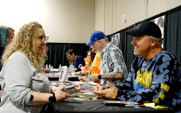 Lisa Anthony, left, meets with actor Adam Baldwin at the Gem State Comic Con in May. Lines for Baldwin and fellow Firefly castmates Jewel Staite and Sean Maher at times stretched half the length of the meeting hall. (PHOTO: MARC LUTZ, IBR)