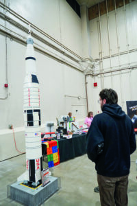 An attendee at the Gem State Comic Con on May 15 looks at a 30,000-piece rocket built from LEGO by IdahoLUG with the help of elementary students. (PHOTO: MARC LUTZ, IBR)