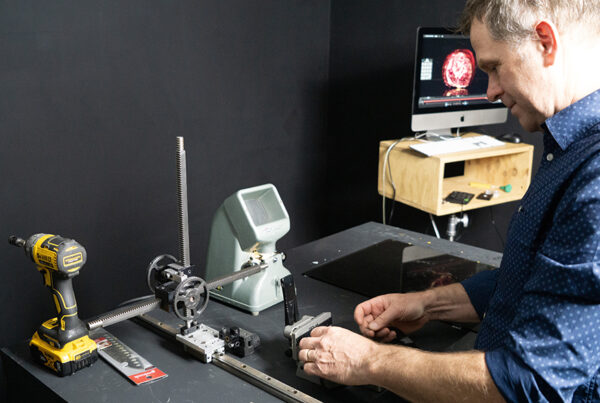 Larsen demonstrates how a film splicer works. (PHOTO: MARC LUTZ, IBR)