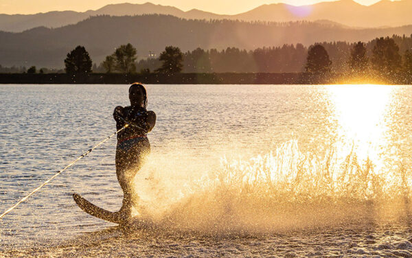 A slalom water skier carves a rooster tail on Lake Cascade at Tamarack Resort near Donnelly. America's only ski, golf, and lake resort is opening a 100-slip marina that also offers on-water fuel, a sandy public beach and swimming area, lakeside dining and retail, and a full suite of motorized and nonmotorized watercraft rentals. One of 14 Ski Idaho destinations opening this summer, the resort also offers lift-served mountain biking, Idaho's number-one public golf course, disc golf, ziplines, pickleball, guide whitewater rafting and fishing trips, a spa, an array of dining options, onsite lodging, and a slew of special events. (Photo by Sherri Harkin for Tamarack Resort)