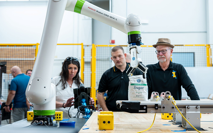 Graduate researchers Sarah Davis (left) and Hunter Hawkins (center) work with research faculty John Shovic to find AI solutions for a safety and productivity issue at Amalgamated Sugar. (PHOTO: U OF I)