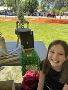Tessa Johnson, who attended previous camps run by Oregon-based Girls Build, poses with her projects, including an electrical box cat. (PHOTO: LET'S BUILD IDAHO)