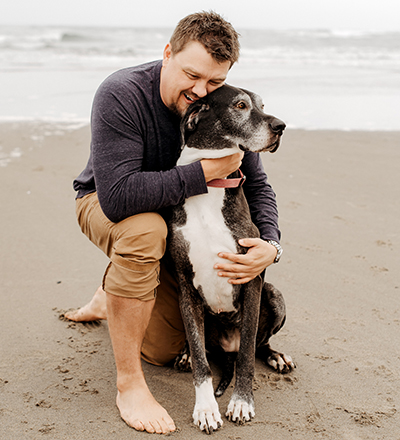 Co-founder Jared McLean is with Lucy, whose 120-pound frame inspired the company name. (PHOTO: THE BIG DAMN DOG CO.)