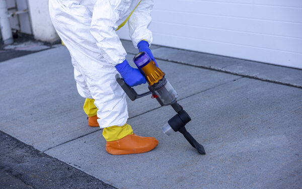 Researcher using the collection device to collect mock nuclear fallout debris. (PHOTO: INL)